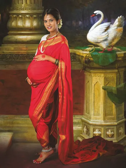 Inspired by the timeless art of Ravi Varma, this is a truly special traditional maternity portrait. We created a rich, painterly look to celebrate motherhood with classic Indian elegance in a red saree.