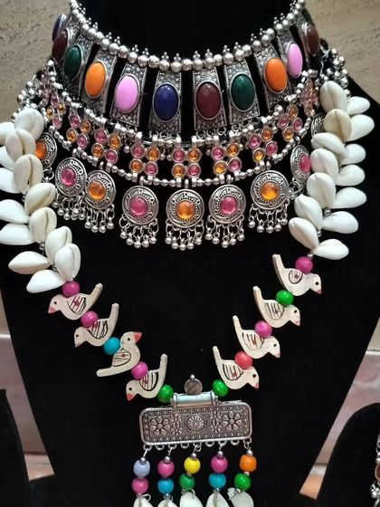 A quirky and fun oxidised set featuring shell and bird motifs, perfect for a Mehendi or Haldi function.