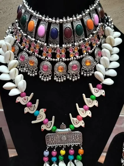 A quirky and fun oxidised set featuring shell and bird motifs, perfect for a Mehendi or Haldi function.