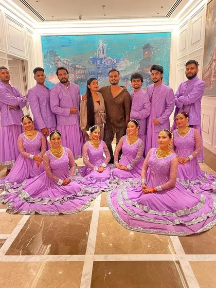 A moment with my incredible team after a fantastic show. Dressed in coordinated lavender outfits, this picture captures the unity and professionalism of our artists.