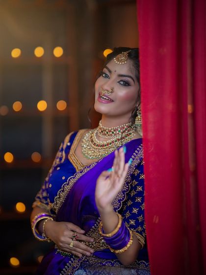 A playful close-up showing the maang tikka, nose ring, and choker from our temple jewellery collection.