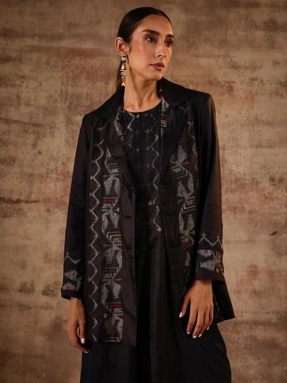 For this look, I styled a black printed jacket over a matching dress to create a sophisticated, layered ensemble. This demonstrates how traditional patterns can be integrated into modern, structured tailoring for a powerful effect.