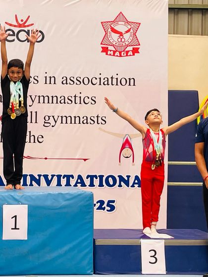 Two young gymnasts on the podium at the Infinity Leap Invitational. We foster a healthy competitive spirit from the very beginning.