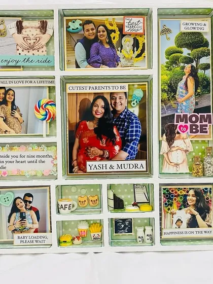 A beautiful frame created as a baby shower gift, capturing the nine-month journey of pregnancy with photos, quotes, and miniature cravings.