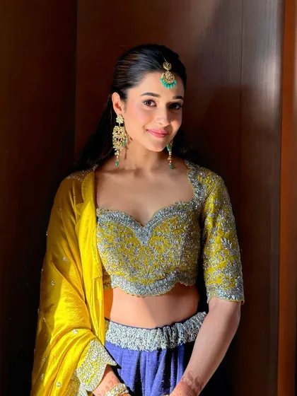 Another beautiful shot of the haldi glam, highlighting the fresh, radiant skin and the subtle eye makeup.
