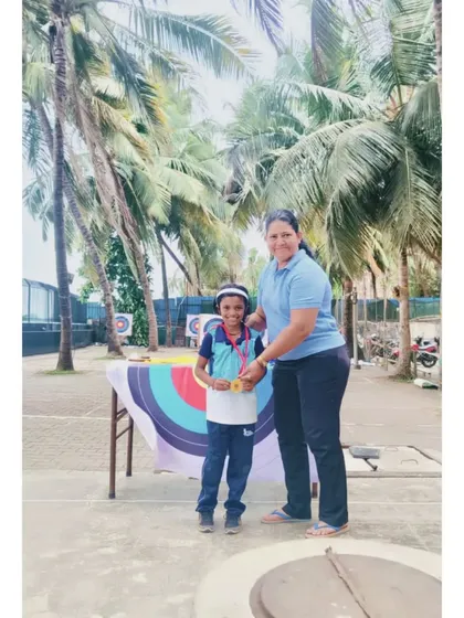 A young archer receiving his medal. These moments build a strong foundation of confidence and sportsmanship.