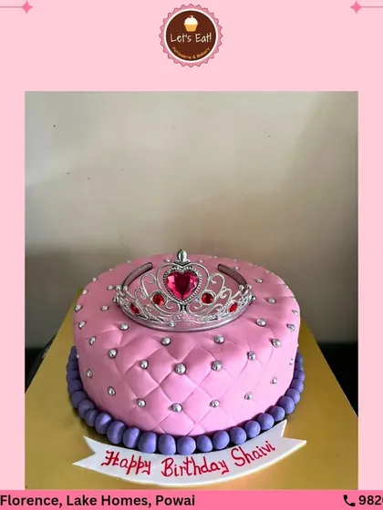 A cake truly fit for royalty. This princess cake is decorated with a quilted pink fondant pattern, silver dragées, and a sparkling tiara on top, perfect for a glamorous birthday celebration.