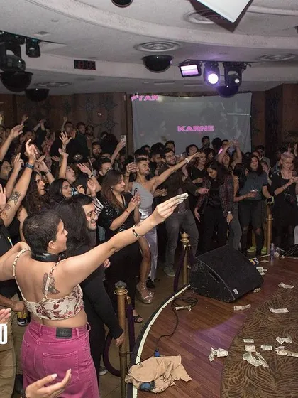 The audience captivated by a drag performance. Creating these moments of connection and celebration between queer artists and the community is why I do this work.