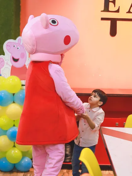 Imagine the look on your child's face when their favorite character joins the party. Here, Peppa Pig gives the birthday boy a special hug, creating a magical moment he'll never forget.