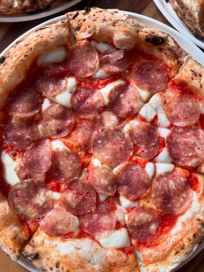 A beautiful salami pizza, perfectly cooked and ready to be enjoyed.
