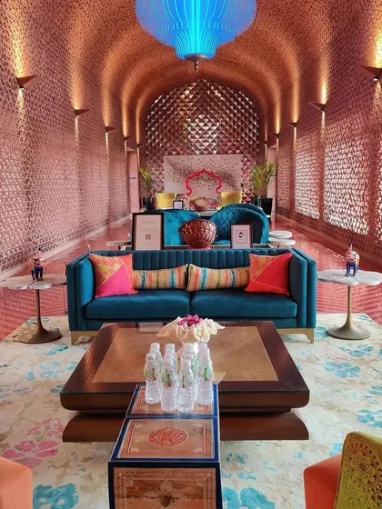 Another view of the magnificent lobby at Taj Devi Ratn, showcasing the interplay of light, texture, and color. The design uses a rich palette of teal, orange, and gold to create a warm and opulent atmosphere that feels both grand and welcoming.
