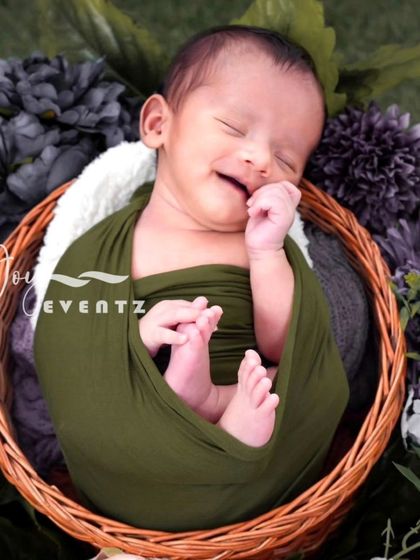 The pure bliss of a newborn's smile is a moment to cherish forever. We specialize in newborn photography in Bangalore, ensuring a safe and comfortable session where your baby is gently swaddled and posed in our cozy, floral-themed props.