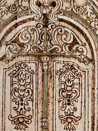 Detail of the ornate carvings on the wooden door. Pyrography allows for such fine, intricate work that brings the design to life.