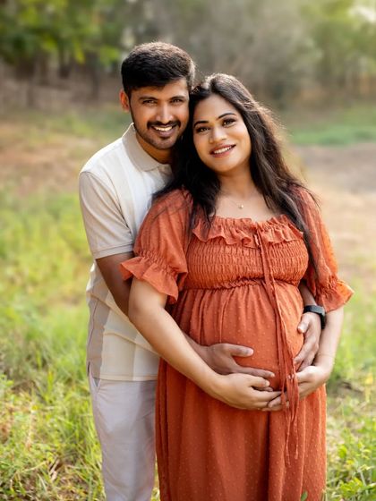 A beautiful, smiling portrait of the couple, framed by the natural beauty of the woods. A perfect capture of their shared joy.