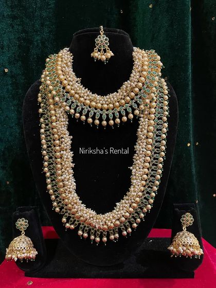 A heavy pearl and green bead set that is perfect for a grand, opulent look.