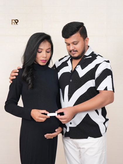 The journey begins. This creative shot captures the couple looking at their positive pregnancy test, a powerful and emotional start to their parenthood story.