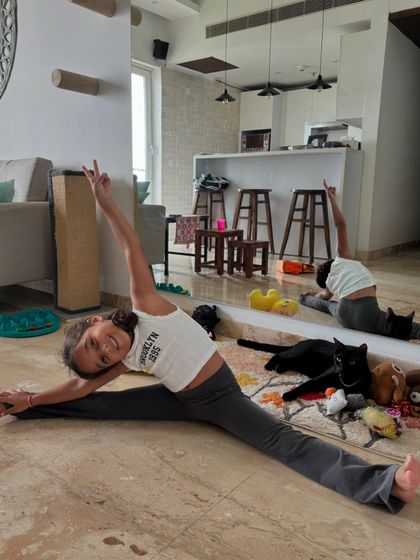 Our 5-year-old superstar Mia nailing her splits, with our cat Bro casually photobombing. Flexibility and fun go hand-in-hand here.