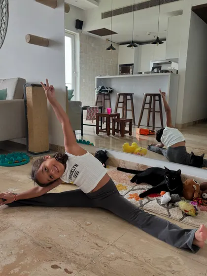 Our 5-year-old superstar Mia nailing her splits, with our cat Bro casually photobombing. Flexibility and fun go hand-in-hand here.