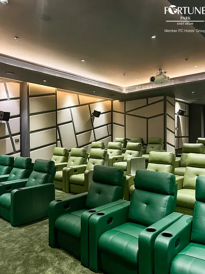 A closer look at our custom-designed seating. Each of the 31 seats is a plush, light green leatherette recliner, complete with its own cupholder, offering unparalleled comfort for any event, from a short film to a marathon movie screening.