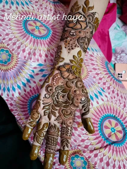 A lovely bridal design featuring a mix of green and black henna for a unique, multi-dimensional effect.