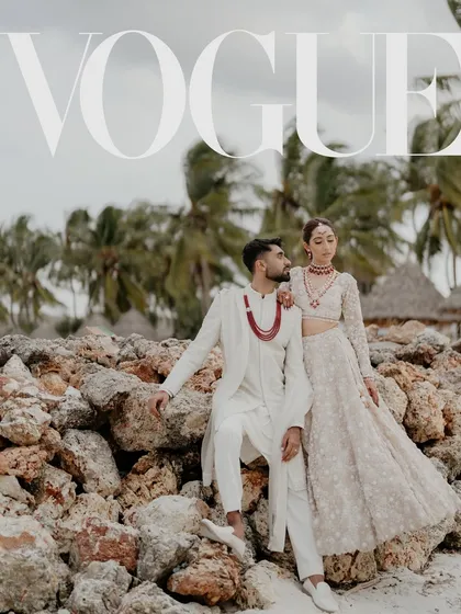 This editorial-style shot of Dhwani and Vishal on the rocky shores of Zanzibar was part of their Vogue India spread. Their coordinated white outfits against the palm trees and stones created a stunning, high-fashion destination wedding portrait.