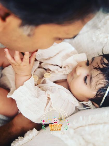 A tender moment between a father and his daughter. These quiet, gentle interactions are just as powerful as the big smiles. It's about capturing that feeling of safety and love.