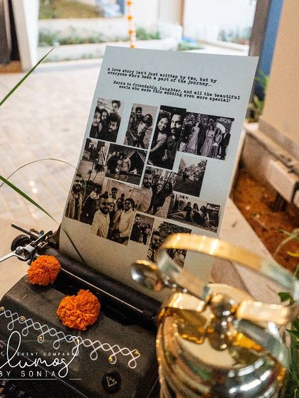 A personalized story corner with a vintage typewriter and a collage of the couple's photos.