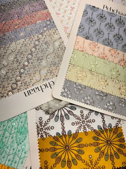 A vibrant collection of embroidered and patterned fabrics from our 'Pehchaan' collection, perfect for creating unique traditional wear.