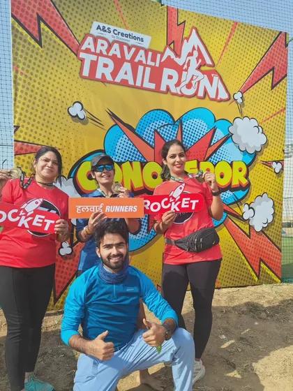 Fun at the photo booth. Participants from the Aravali Trail Run showing their "Rocket" and "Halwai Runners" signs.