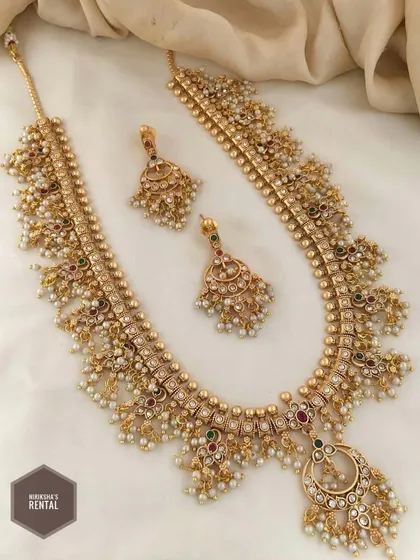 This image shows the choker from the previous photo paired with a matching long necklace, available to rent as a complete set.