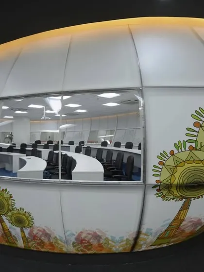 Innovation at its best. We used stretch ceiling fabric to create the outer "skin" for this pod-like Network Operations Center (NOC) room, with custom graphics printed on it.