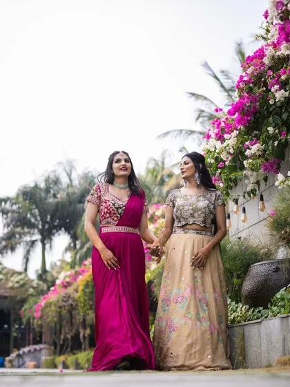 A candid walking shot of the bride and her bridesmaid. The makeup for both was designed to be long-lasting and picture-perfect for the entire event.