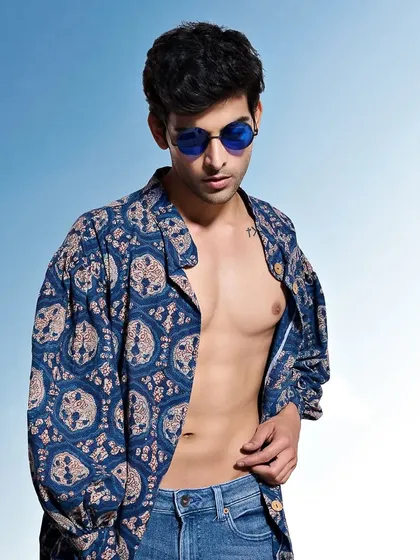 A relaxed, full-torso shot for a menswear catalogue. The open shirt and casual pose give a laid-back feel to this block-printed piece.