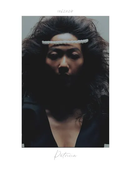 A creative portrait from the 'Patricia' series, styled to look like a polaroid. The focus is on the model's intense gaze and the unusual hair accessory, creating a raw and artistic feel.