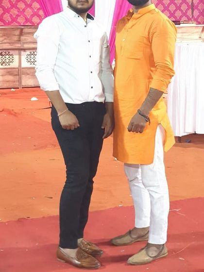 Here you can see a client wearing a white shirt and black trousers I stitched, standing next to a friend in a kurta. My tailoring covers both formal and ethnic wear needs.