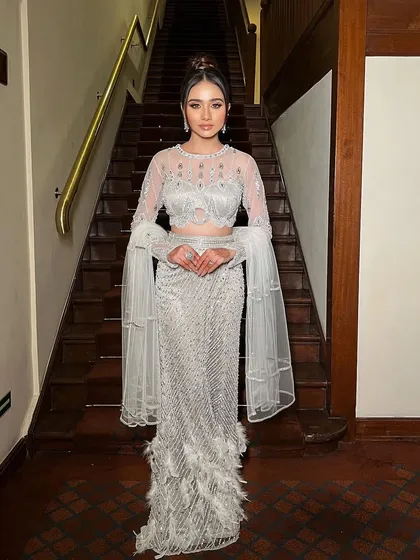 A full-length shot of the "Viraaya" look on a grand staircase. The styling is perfect for a glamorous reception or red carpet event.