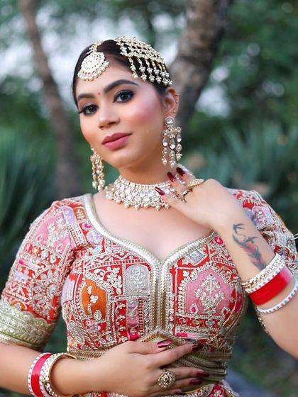 A close-up portrait highlighting the bride's confidence. The makeup is bold yet elegant, with a perfectly blended base and a lip color that ties the whole look together.