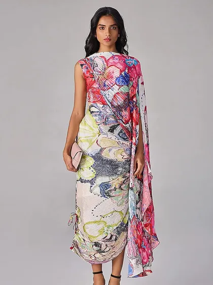 A wearable canvas. This draped dress features a vibrant, abstract floral print, transforming a simple silhouette into a piece of art.