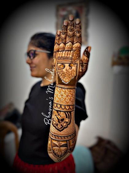 A student proudly displays the full bridal back-hand design she completed during a class demo. This is the result of dedicated practice and expert guidance.