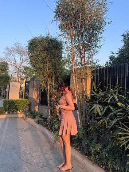 A side view of the pink mini dress, showing its backless design.