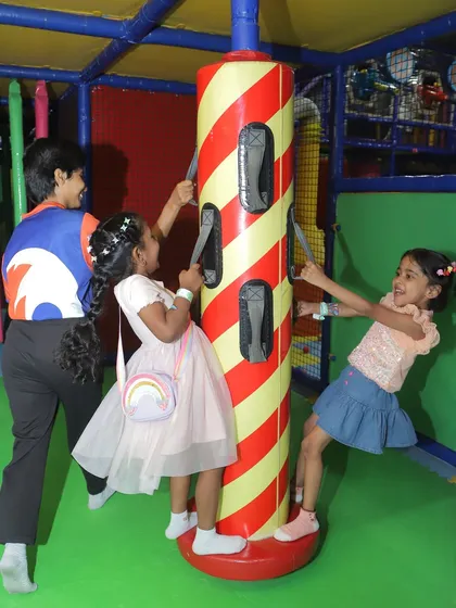 Laughter and fun around the spinning pole. Our play equipment is designed for multiple children to enjoy at once, making it perfect for energetic party groups.