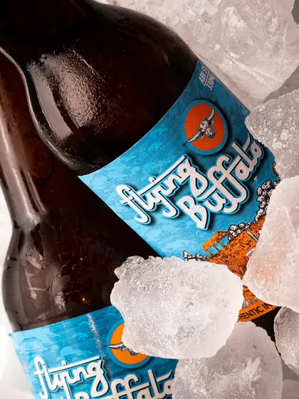 A tighter close-up on the beer bottles in ice, focusing on the condensation and the crisp logo. Detail shots like this add texture to a product page.