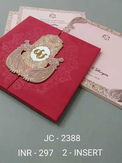 This bold red gate-fold invitation features a large, ornate peacock-shaped emblem with an 'Om' symbol. It's a vibrant and unique design for a traditional Hindu wedding.