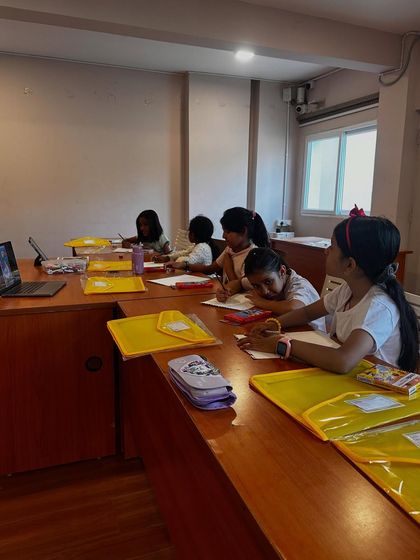 A view of our classroom, where an online student participates on the laptop alongside our in-person attendees.
