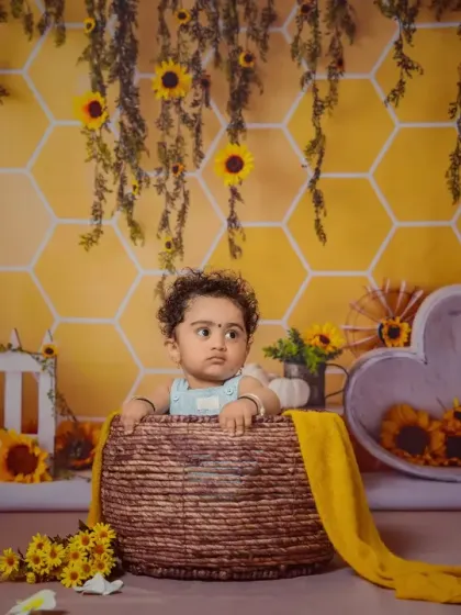 A thoughtful look from a baby in the honey bee basket.