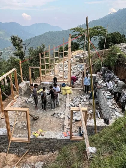 Our team works with local craftsmen to erect the timber window frames for the guesthouses in Vasudev. This collaborative, on-site process is essential for building complex structures in such a challenging, remote environment.