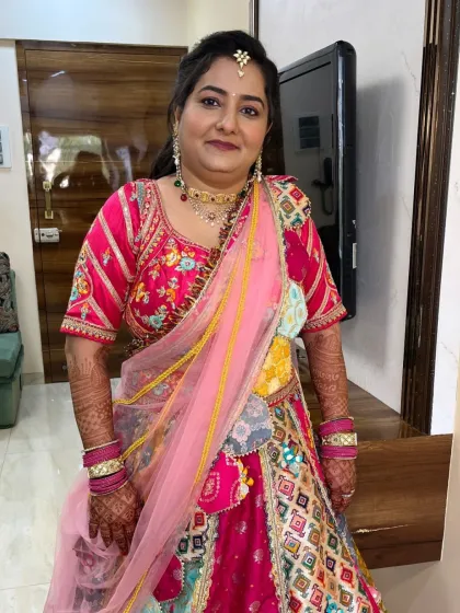 A beautiful client in a colorful lehenga, ready for a wedding celebration. Her makeup is soft and pretty.