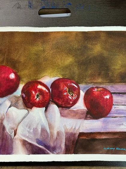 A still life of apples on a wooden surface, from my watercolor course. The focus is on capturing the shiny, reflective surface of the apples.