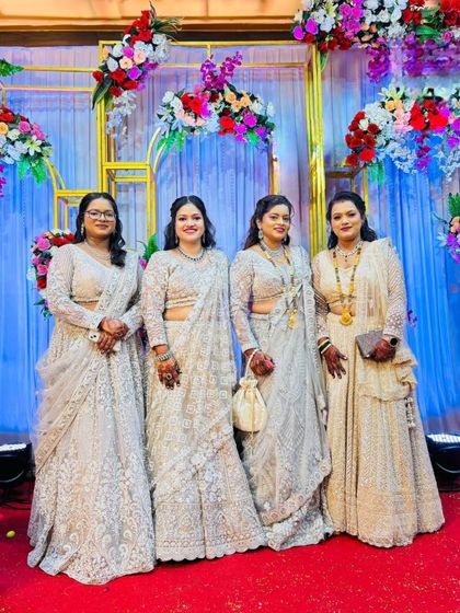 A family of beautiful ladies all dressed in coordinated white and silver outfits rented from my store for a wedding.