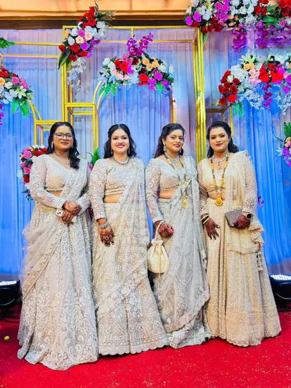 A family of beautiful ladies all dressed in coordinated white and silver outfits rented from my store for a wedding.